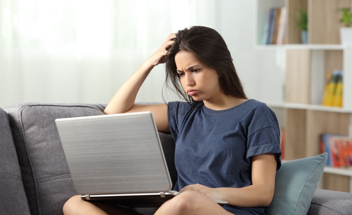 photo of a confused woman looking at a laptop